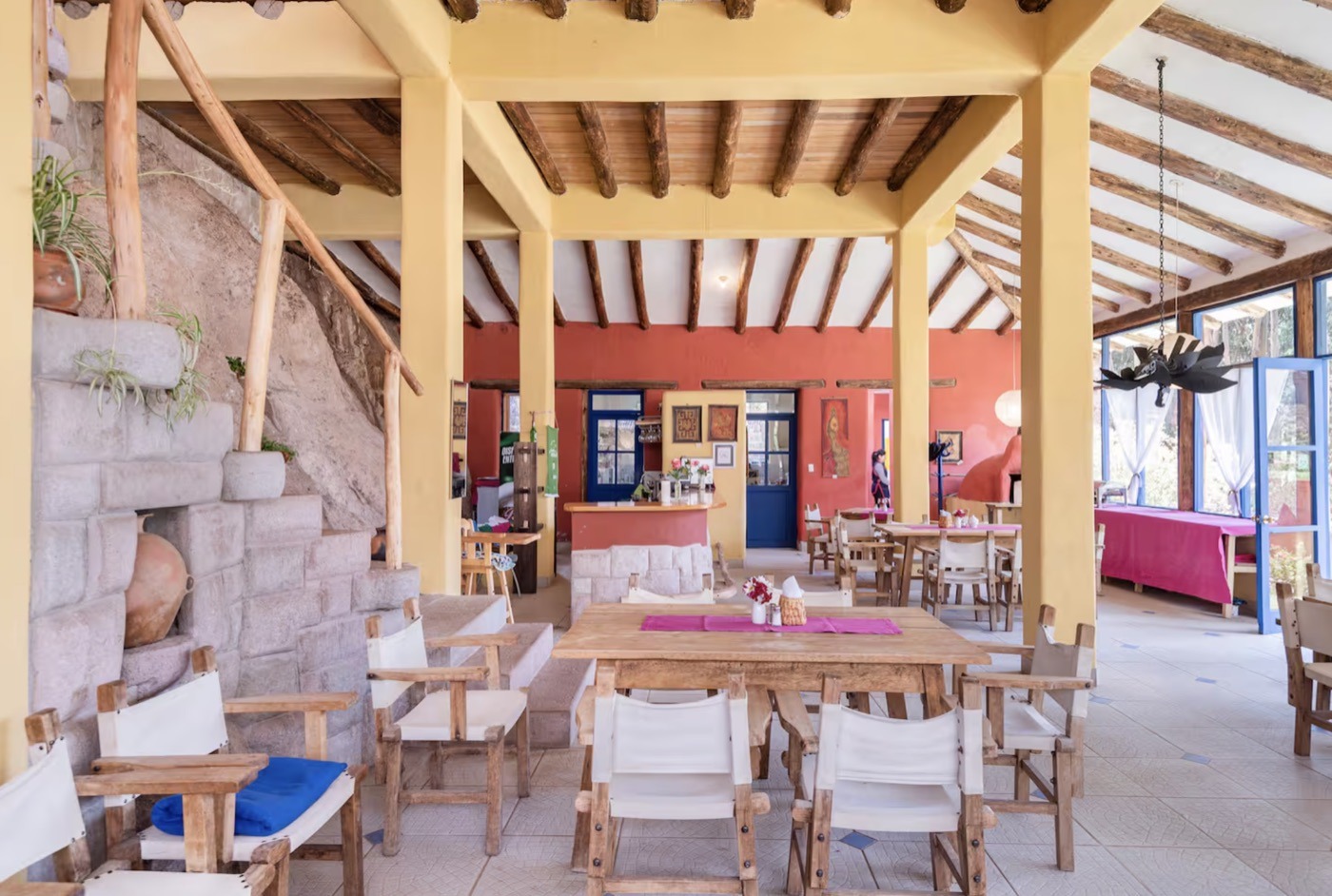 The covered dining terrace with wooden tables