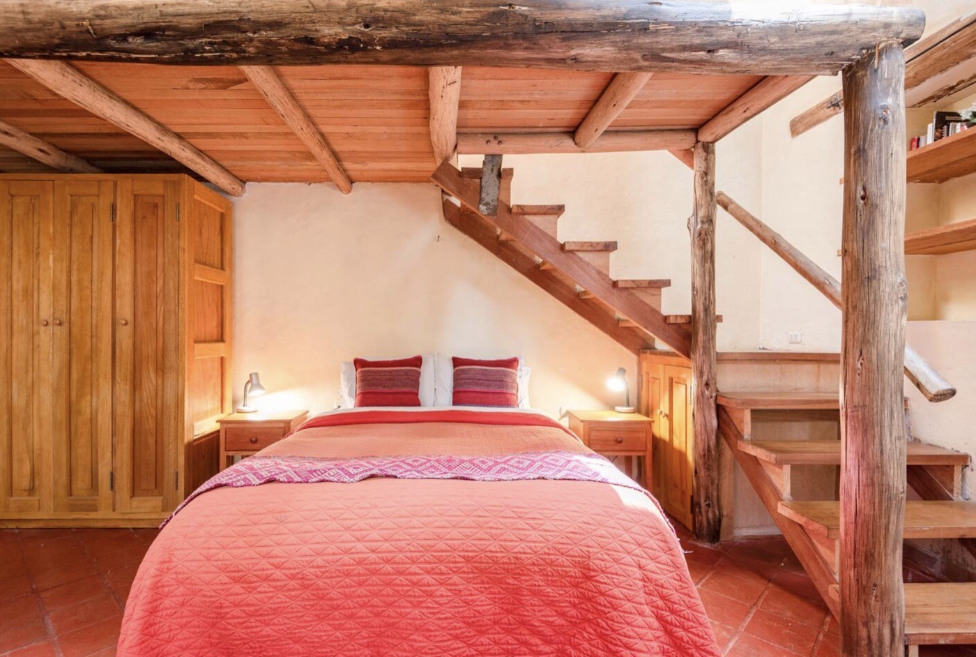 A loft room with a wooden staircase