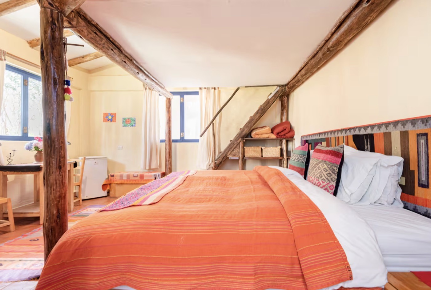 A shared room with a wooden staircase
